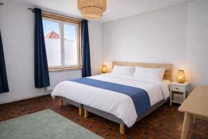 a bedroom with a large bed with a window at Appartements Entiers - Centre de Tournai in Tournai +25 photos