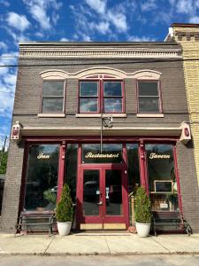 a building with red doors and windows on a street at Iron Horse Station in Hot Springs