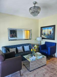 a living room with a blue couch and a table at Hotel La Llave del Mar Zona Colonial in Santo Domingo