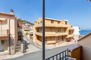 a view from a balcony of a street with buildings at Bed and Breakfast Cala Luna in Castelsardo