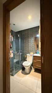 a bathroom with a shower and a toilet and a sink at Appartemet city centre kenitra in Kenitra