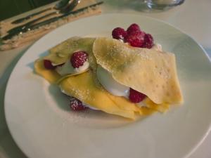 a white plate with a dessert with berries on it at Avery House Bed & Breakfast in Galena