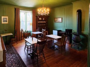 a dining room with tables and chairs and a stove at Avery House Bed & Breakfast in Galena
