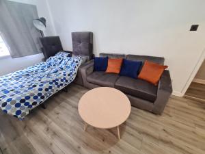 a living room with a couch and a table at Mailbox and Broad St in Birmingham