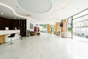 a large lobby with a white marble floor and windows at A25 Premium Hotel - 36 Giang Văn Minh in Hanoi