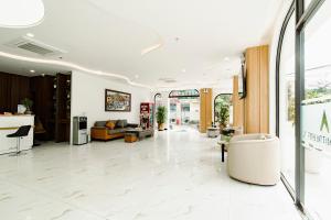 a lobby of a store with white tile floors at A25 Premium Hotel - 36 Giang Văn Minh in Hanoi