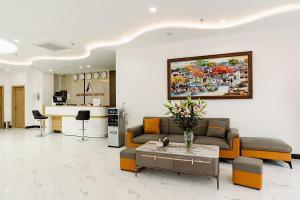 a living room with a couch and a table at A25 Premium Hotel - 36 Giang Văn Minh in Hanoi