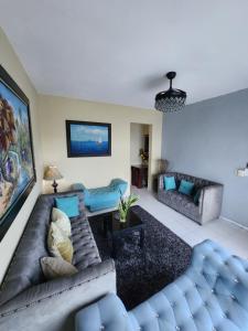 a living room with a couch and a table at Hotel La Llave del Mar Zona Colonial in Santo Domingo
