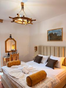 a bedroom with a large bed with brown pillows on it at Wiena Apartments in Ulcinj