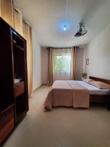 a bedroom with a large bed and a window at Faraja Homestay Mwanza in Mwanza