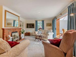 a living room with two couches and a fireplace at 1 Bed in Lymington oc-92403 in Ripley