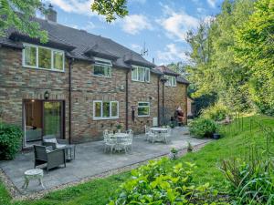 a brick house with a patio in the yard at 1 Bed in Lymington oc-92403 in Ripley