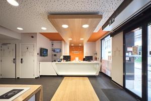 an office with a desk in the middle of a room at easyHotel Brussels City Centre in Brussels