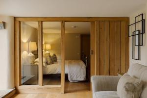 a bedroom with sliding glass doors with a bed at Dunsa Cottage Bakewell Peak District in Bakewell