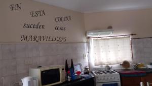 a kitchen with a stove and a microwave at Brisas Pura in Tandil