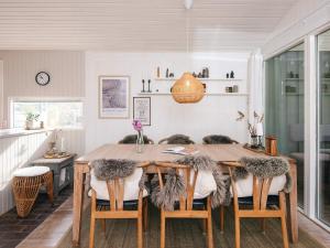 a dining room with a wooden table and chairs at Idyllic Nature Retreat - By Traum Ferienwohnungen in Ulfborg +39 photos