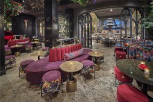 a restaurant with purple furniture and tables and chairs at Paris Las Vegas Hotel & Casino in Las Vegas