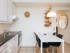a kitchen with a white table and chairs at 7 person holiday home in Ringkøbing in Ringkøbing