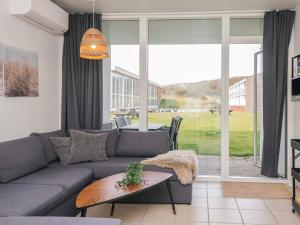 a living room with a couch and a table at 7 person holiday home in Ringkøbing in Ringkøbing