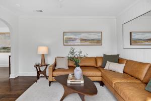 a living room with a brown couch and a table at 10th St Retreat in Boise