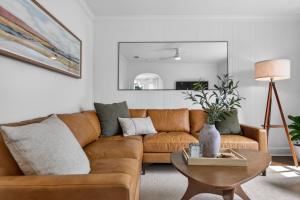 a living room with a brown couch and a table at 10th St Retreat in Boise