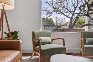 a living room with two chairs and a window at 10th St Retreat in Boise