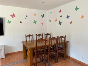 a dining room with a table with butterflies on the wall at Mil Mariposas, Escapada rural Burgos in Barriosuso