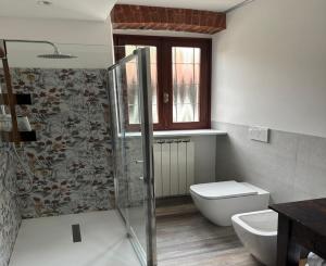 a bathroom with a shower and a toilet and a sink at B&b la bessolina in Ivrea +24 photos
