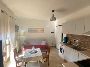 a kitchen and a living room with a bed and a table at Near Sea in Monopoli