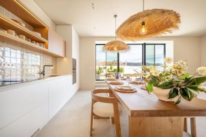 a kitchen with a large wooden table with flowers on it at Villa Flora in Colares