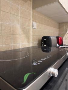 a black counter top in a kitchen at Luxury suite- 1bhk- Near Centaurus in Islamabad