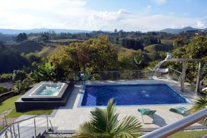 a swimming pool with a view of a mountain at Örök Landscape Hotel in Rionegro