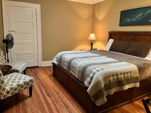 a bedroom with a bed and a chair at Iron Horse Station in Hot Springs
