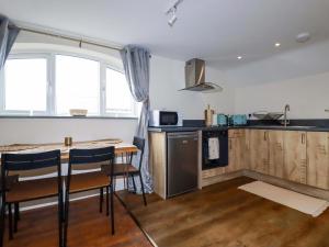 a kitchen with a counter and a table and chairs at The Hideaway in Tintagel +16 photos