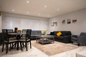 a living room with a table and a couch at Westfield luxurious Apartment in Birmingham