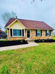 a house with a grass yard in front of it at A Beautiful Sunset in Clarksville