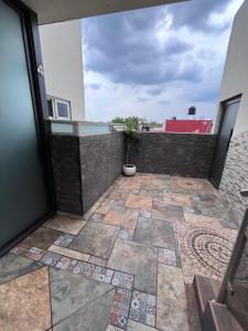 a patio with a potted plant on a building at Casa tequila club jacuzzi 4 in Arandas