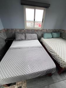two twin beds in a room with a window at Casa tequila club jacuzzi 4 in Arandas +13 photos
