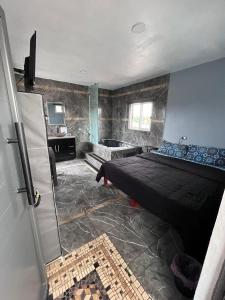 a bedroom with a bed and a tub in it at Casa tequila club jacuzzi 4 in Arandas