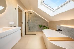 a skylight in a bathroom with a tub and a shower at Villa Flora in Colares +43 photos