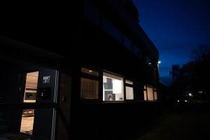 a building with two windows in the dark at Westfield luxurious Apartment in Birmingham