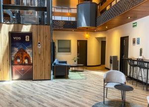 a lobby with a waiting area with chairs and tables at VOS Condesa in Mexico City