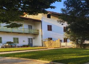a large white building with a balcony and a yard at B&b la bessolina in Ivrea