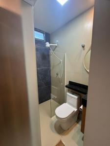 a bathroom with a toilet and a shower at Pousada Complexo Vibe in Baraúna