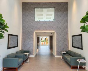 a lobby with couches and a window on the wall at Parque del Lago Boutique Hotel in San José