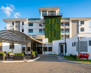 a building with a cow in front of it at Parque del Lago Boutique Hotel in San José