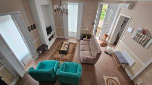 an aerial view of a living room with a couch and chairs at Quinta das Candeias in Candelária