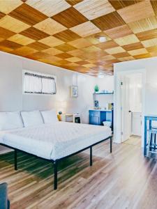 a bedroom with a bed and a wooden ceiling at Fjordline Lodge in Hoodsport