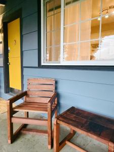 a wooden bench sitting in front of a house at Fjordline Lodge in Hoodsport +2 photos