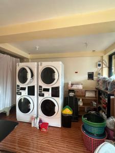 two washing machines sitting in a room at Cris&Mar Homestay Extension in Burgos
